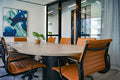 Wide wooden office desk with chairs