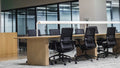 Black office chair beside a wooden desk