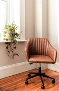Rolling office chair beside a green plant